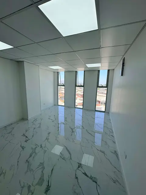 Oficina amplia con piso de porcelanato y ventanales